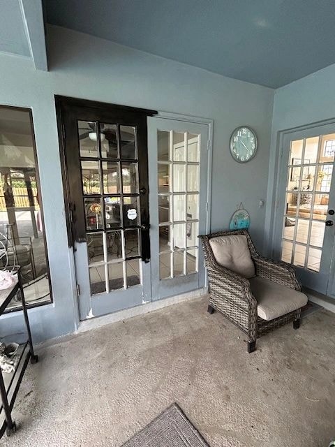 Sunroom with blue-gray French doors and wicker chair — British Heritage painting project