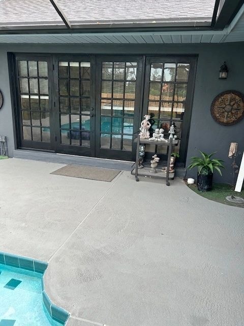 Dark-framed patio glass doors with pool area — British Heritage painting project