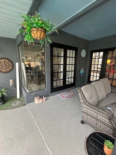 Covered patio with dark walls, French doors and wicker furniture — British Heritage painting project